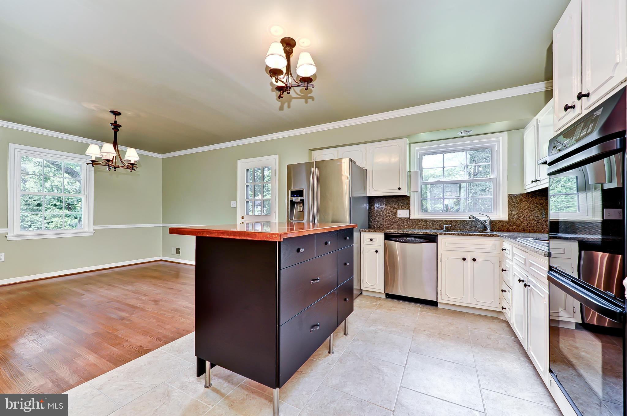8417 Riverside Road Alexandria, VA 22308 - Photo 2 of 30 a kitchen with granite countertop white cabinets and stainless steel appliances