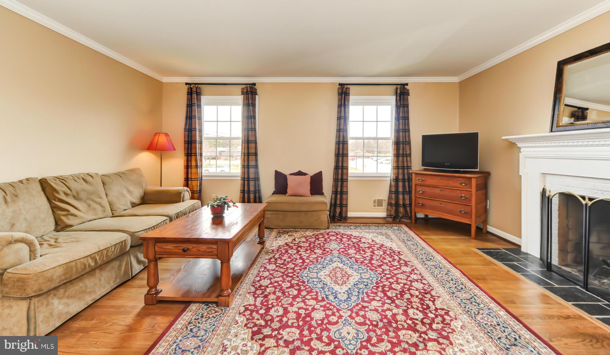 8417 Riverside Road Alexandria, VA 22308 - Photo 11 of 30 a living room with fireplace furniture and a flat screen tv