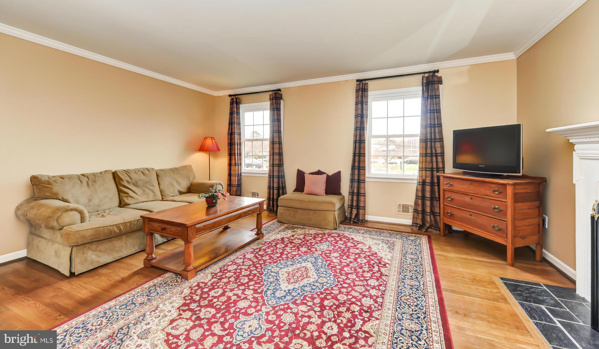 8417 Riverside Road Alexandria, VA 22308 - Photo 12 of 30 a living room with furniture and a flat screen tv