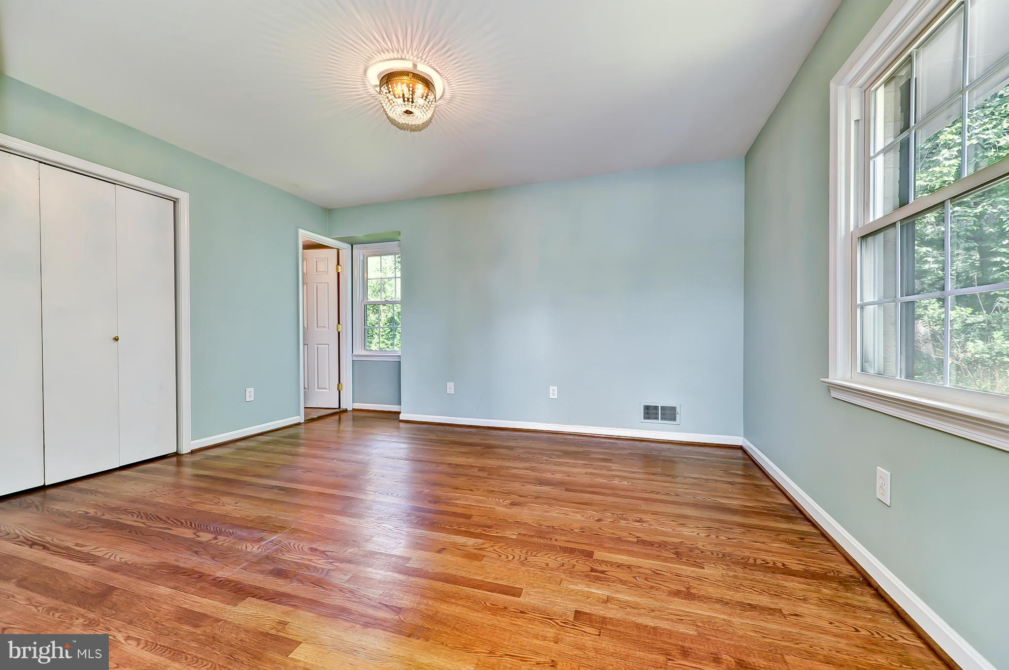 8417 Riverside Road Alexandria, VA 22308 - Photo 17 of 30 a view of an empty room with window and wooden floor