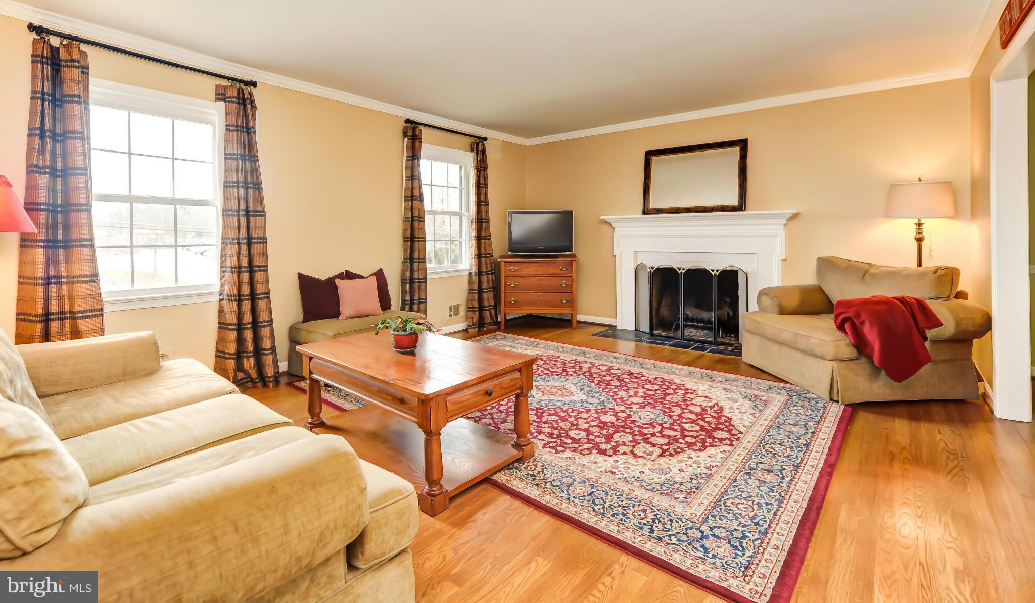 8417 Riverside Road Alexandria, VA 22308 - Photo 3 of 30 a living room with furniture rug and a fireplace