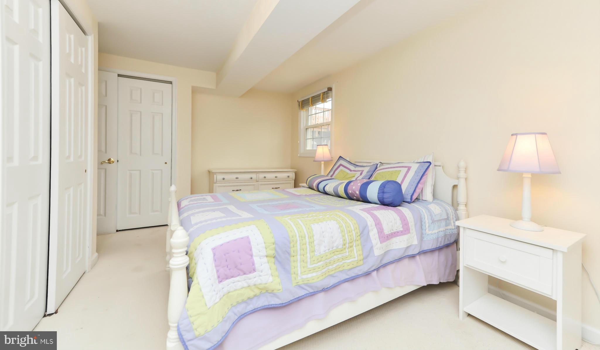8417 Riverside Road Alexandria, VA 22308 - Photo 26 of 30 a bedroom with a bed and a night stand