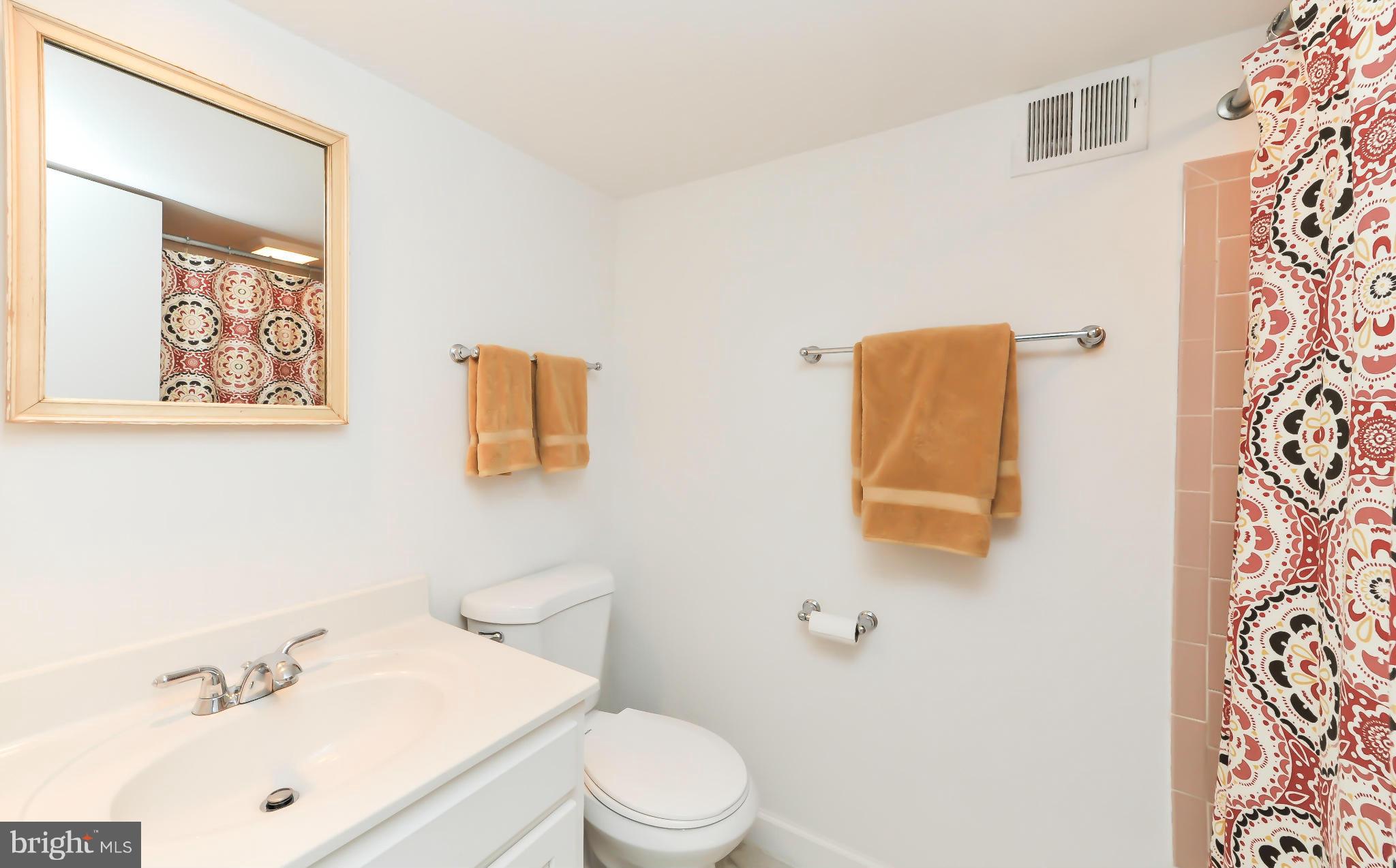 8417 Riverside Road Alexandria, VA 22308 - Photo 29 of 30 a white toilet sitting next to a bathroom sink