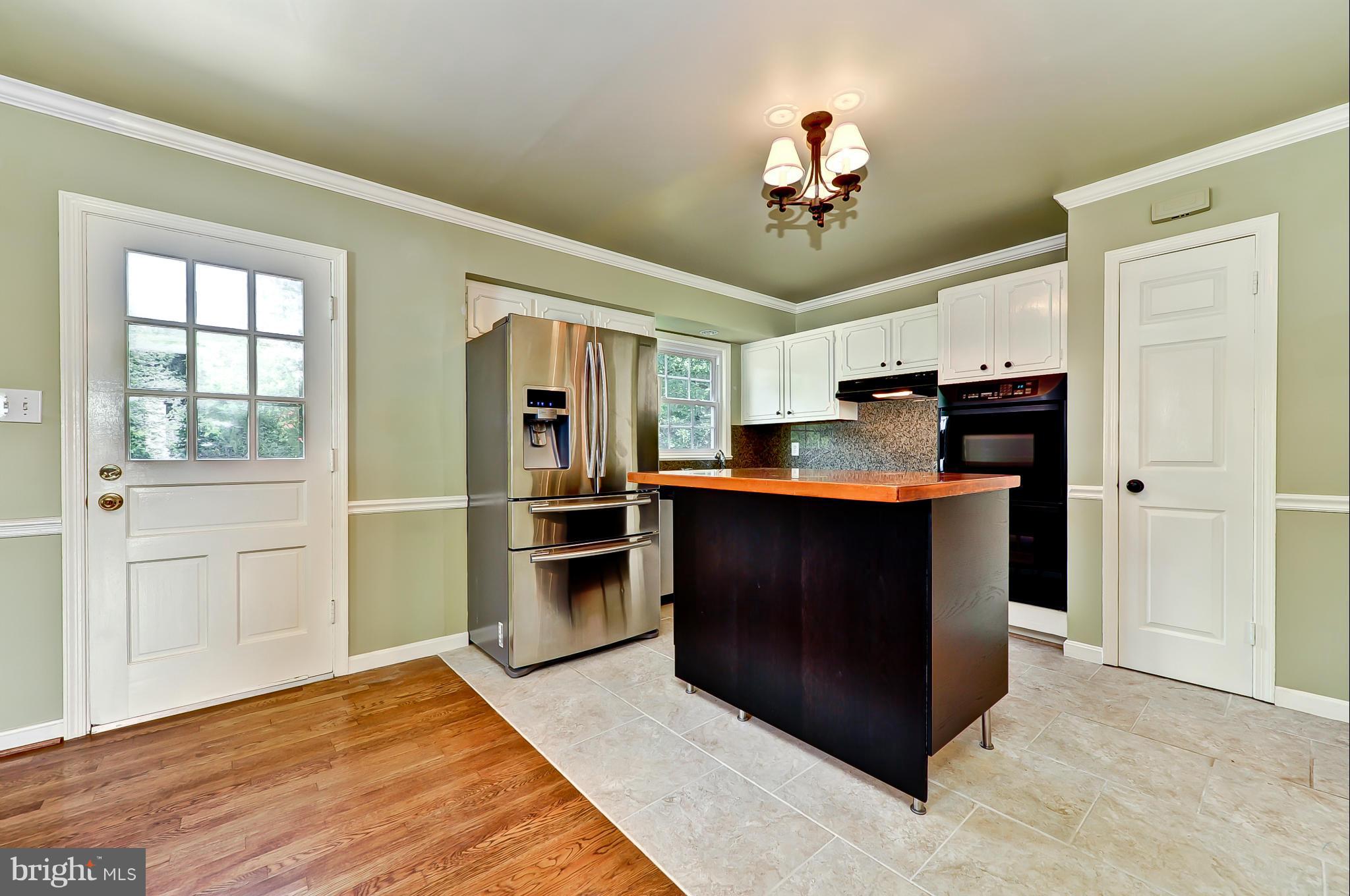 8417 Riverside Road Alexandria, VA 22308 - Photo 7 of 30 a kitchen with granite countertop a refrigerator and a sink