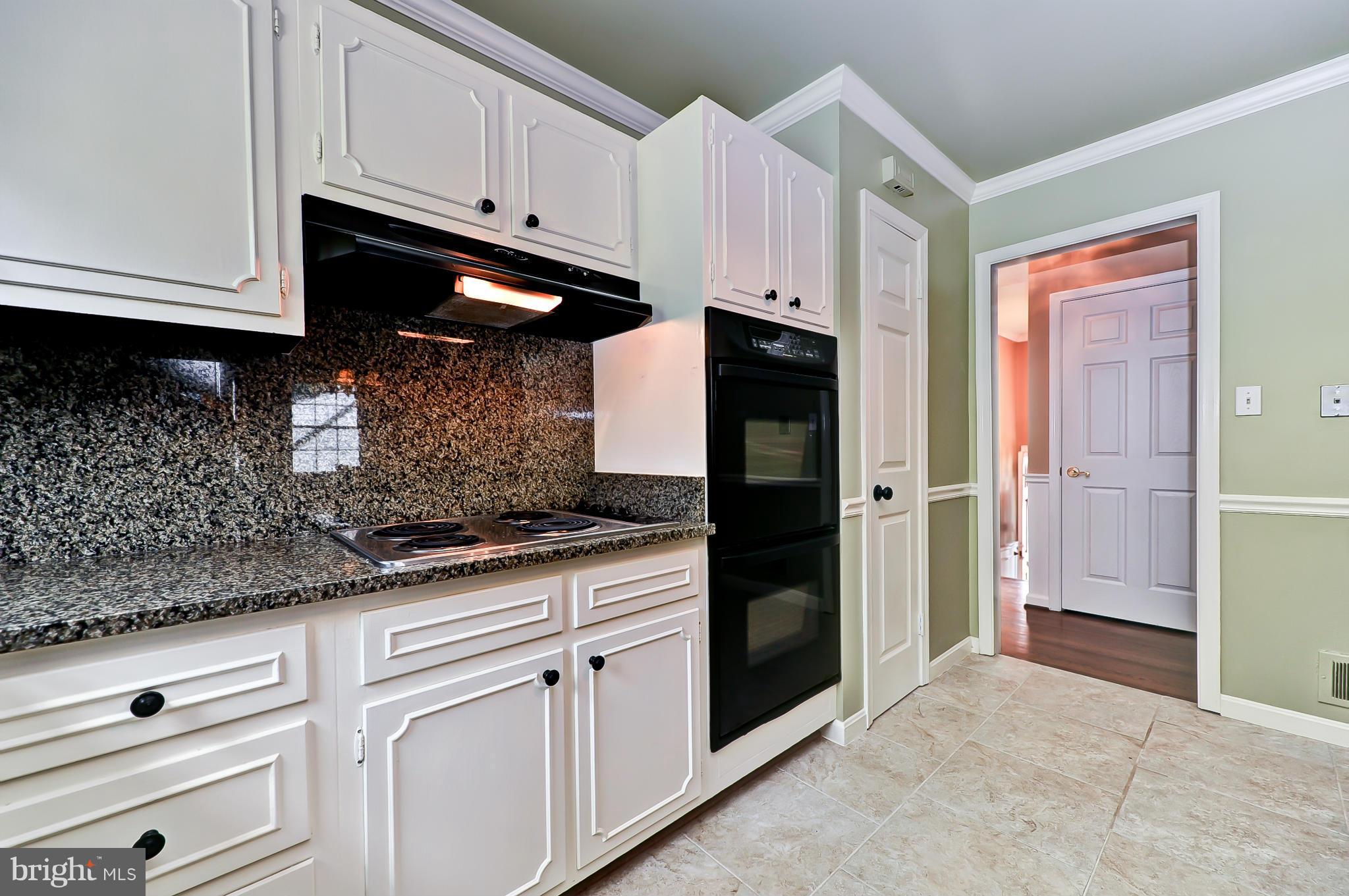 8417 Riverside Road Alexandria, VA 22308 - Photo 8 of 30 a kitchen with granite countertop a sink and cabinets