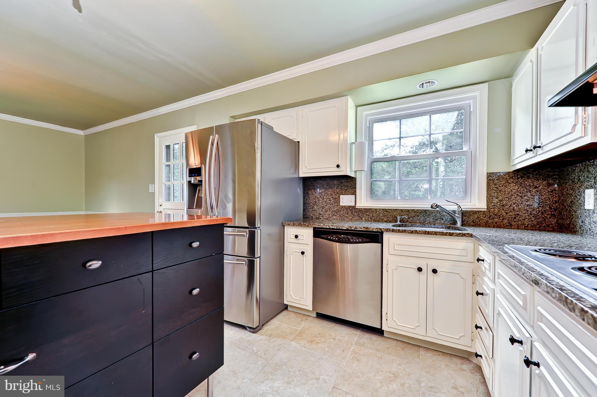8417 Riverside Road Alexandria, VA 22308 - Photo 9 of 30 a kitchen with granite countertop a sink cabinets stainless steel appliances and a window