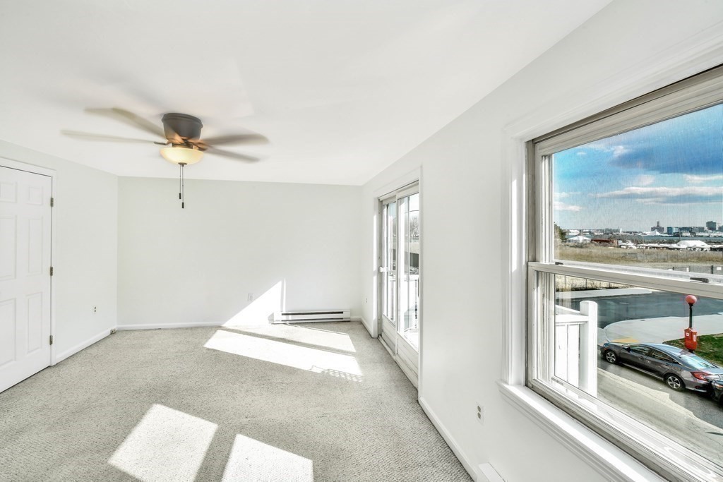 68 Marginal Street, Unit A Boston, MA 02128 - Photo 16 of 21 a living room with furniture and a large window