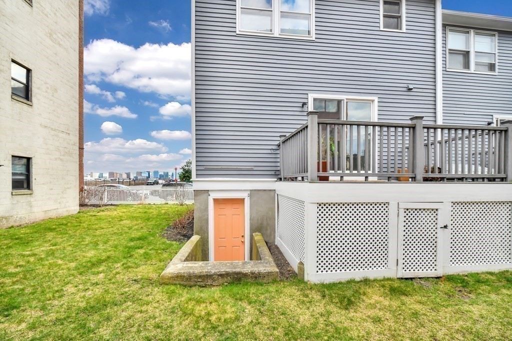 68 Marginal Street, Unit A Boston, MA 02128 - Photo 17 of 21 a front view of a house with a yard