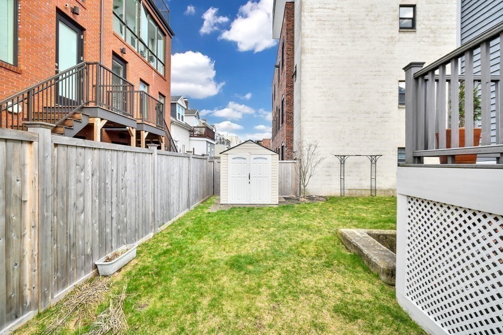 68 Marginal Street, Unit A Boston, MA 02128 - Photo 18 of 21 a view of a house with a yard and sitting area