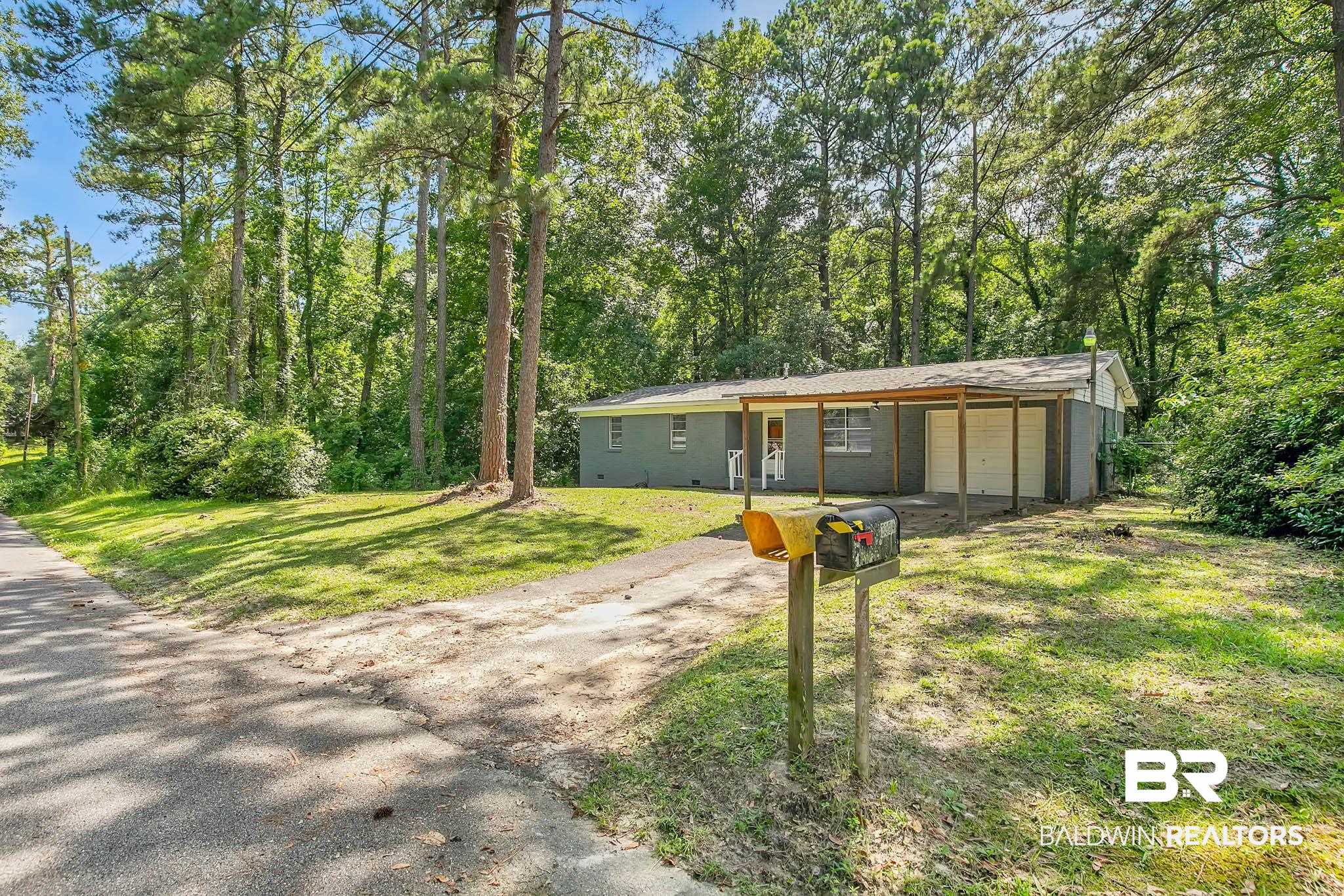3304 Armond Drive Mobile, AL 36605 - Photo 62 of 62 View of front of home featuring dirt driveway, a front yard, and an attached garage