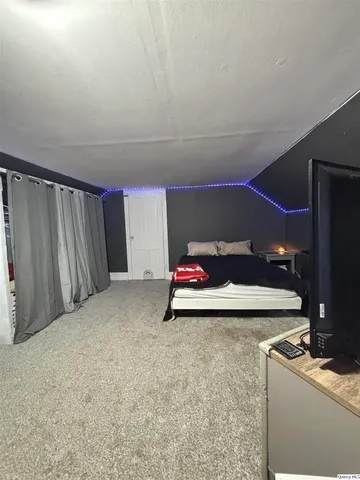 a view of a room with furniture and a flat screen tv