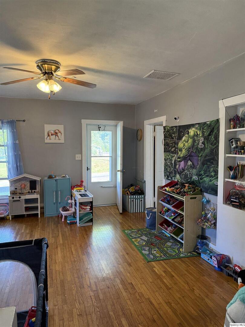212 South 1st Street Carthage, IL 62321 - Photo 10 of 17 a living room with furniture and a flat screen tv