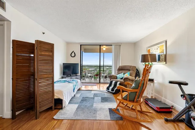 a view of a livingroom with furniture and a flat screen tv