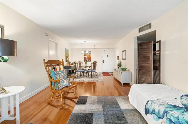 a living room with furniture a rug and a table