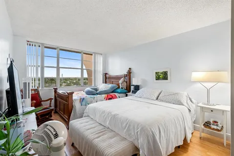 a bed room with two beds and a large window
