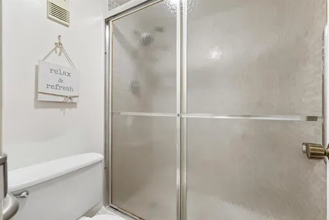 a bathroom with a shower and a toilet