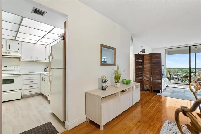a view of a dining room with furniture a chandelier and wooden floor