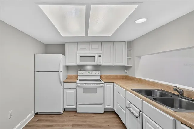 a kitchen that has a sink and a stove in it