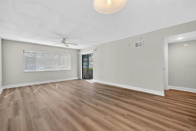 wooden floor in an empty room with a window