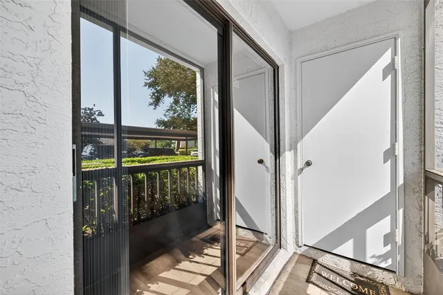 a view of a room with wooden floor and a ceiling fan