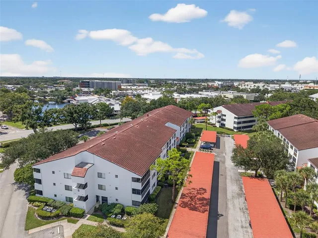 an aerial view of house with yard swimming pool and ocean view