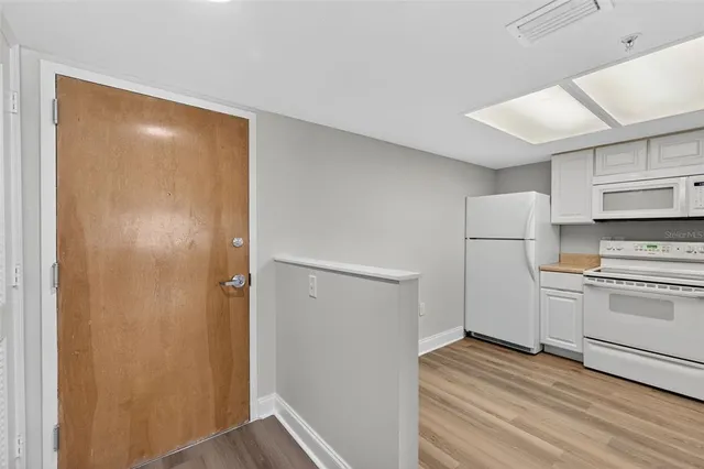 a kitchen with a white cabinets and white appliances