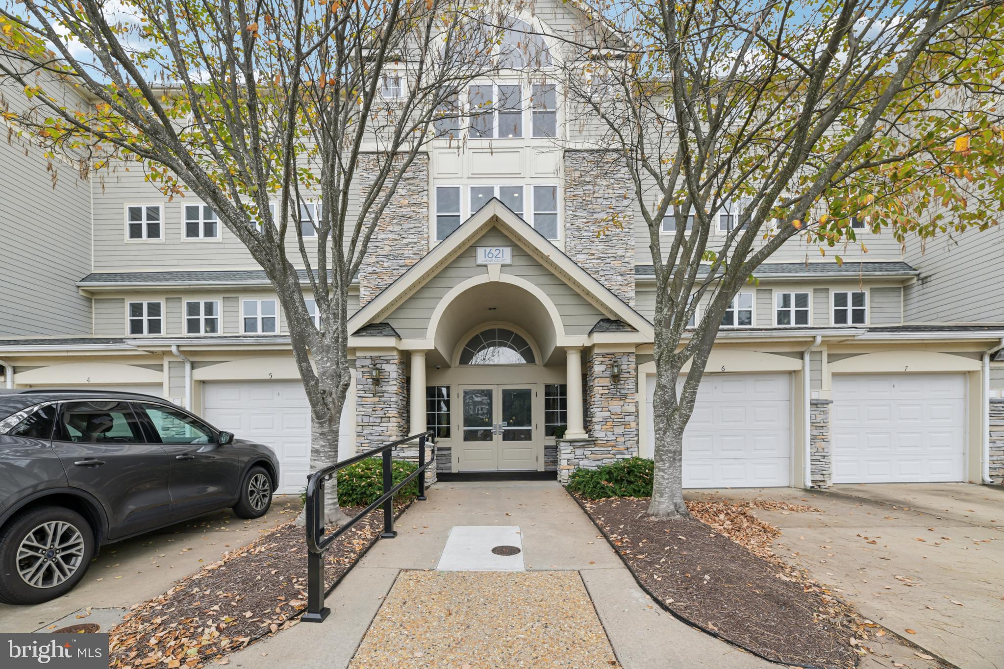 1621 Ladue Court, Unit 207 Woodbridge, VA 22191 - Photo 1 of 33 a front view of a house with a garden