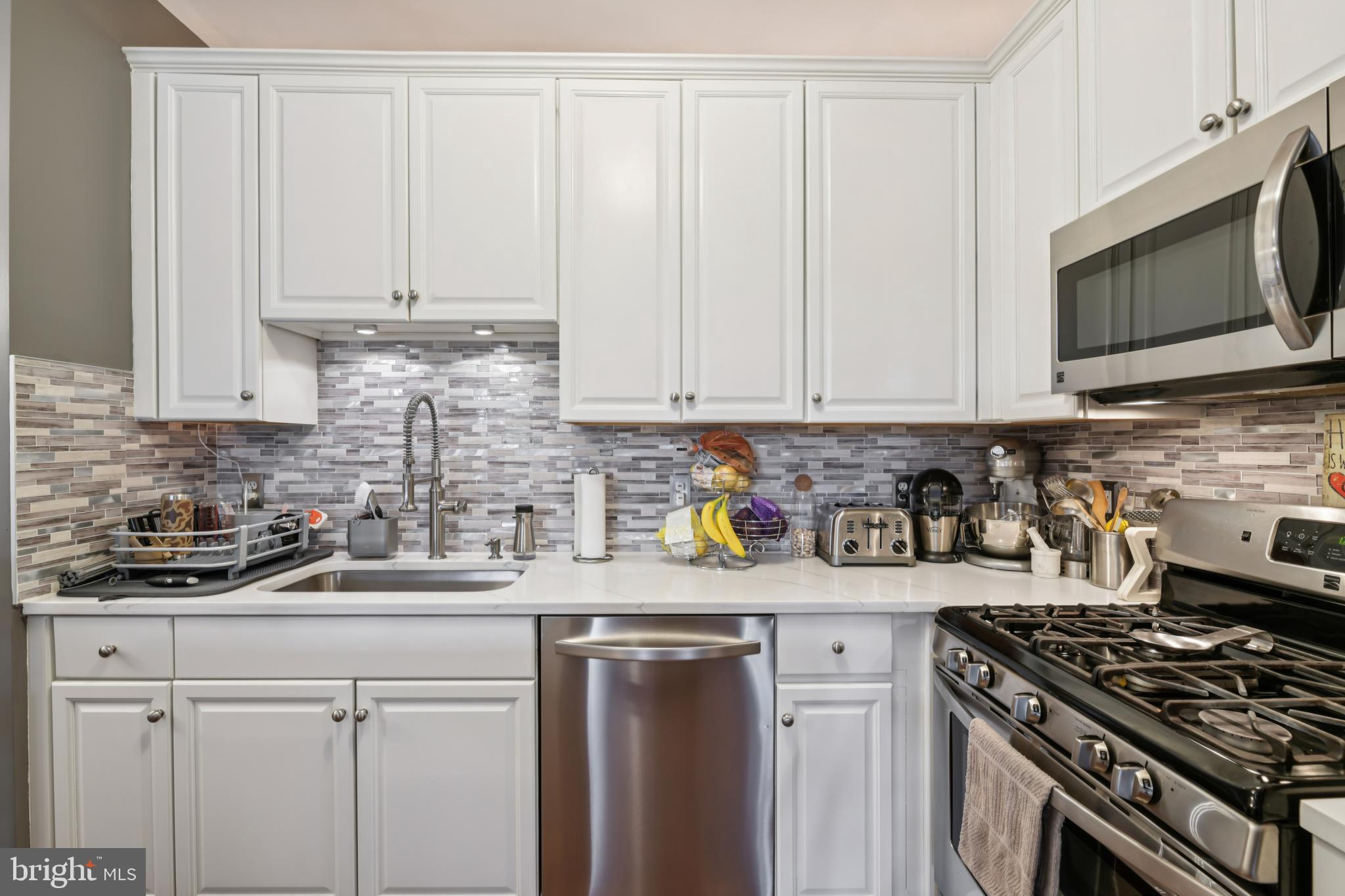 1621 Ladue Court, Unit 207 Woodbridge, VA 22191 - Photo 11 of 33 a kitchen with stainless steel appliances granite countertop a sink a stove a microwave and cabinets