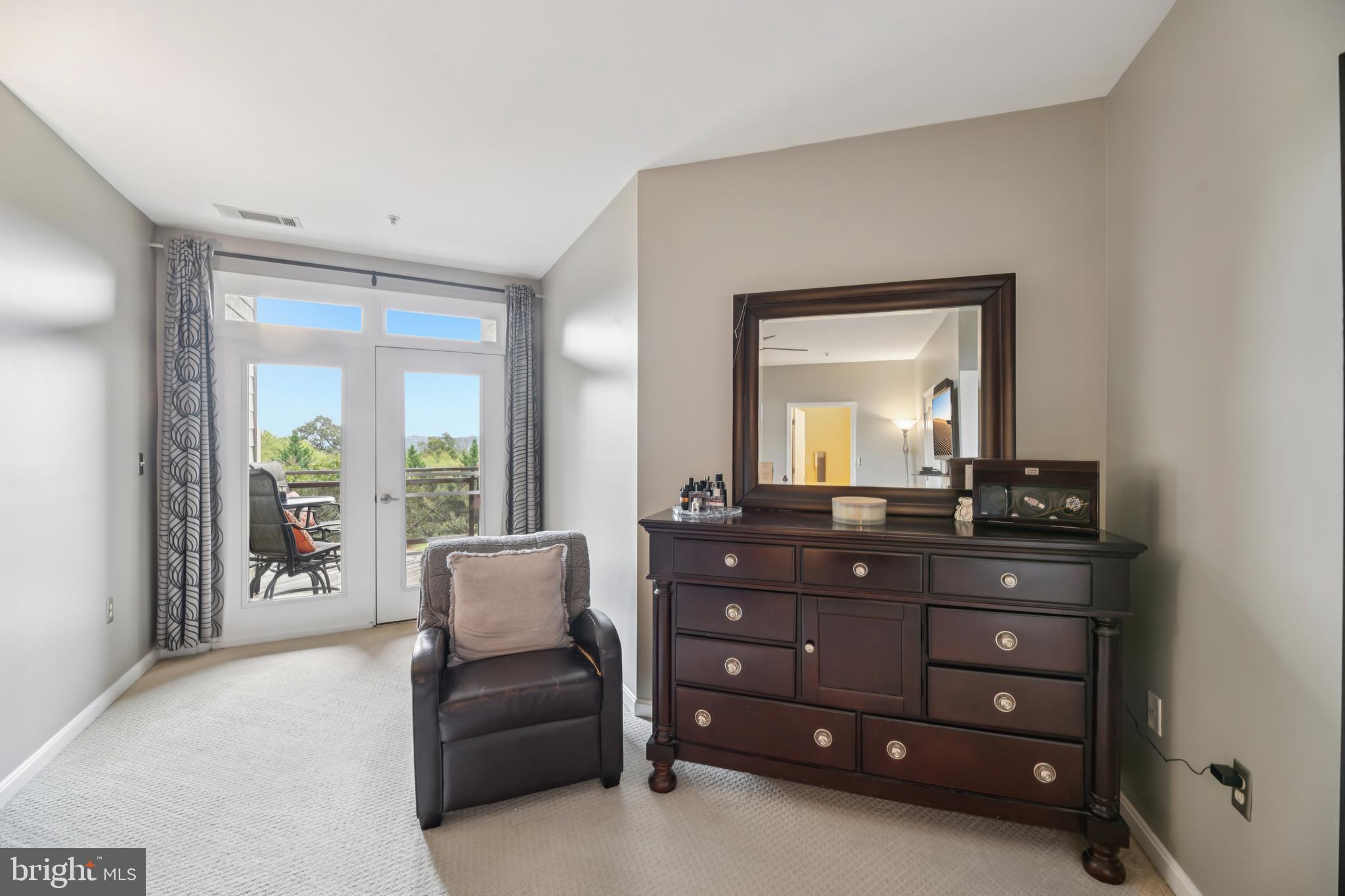 1621 Ladue Court, Unit 207 Woodbridge, VA 22191 - Photo 17 of 33 a living room with furniture and a mirror