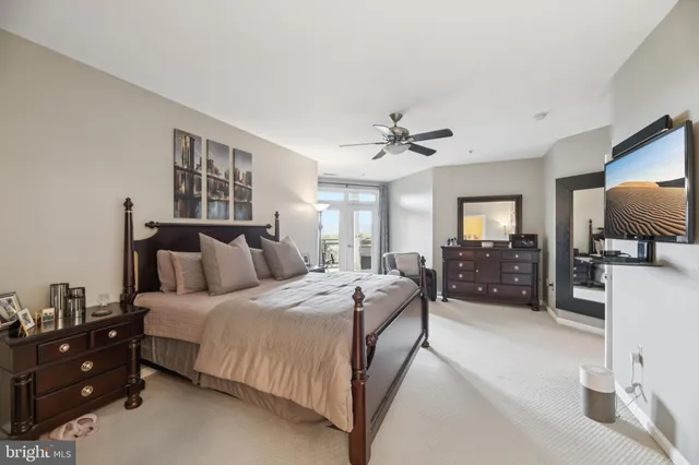 a bed room with a bed window and a television