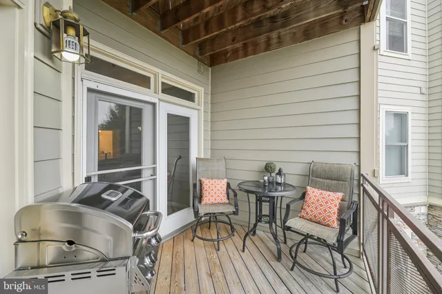 a view of a chairs and table in the balcony
