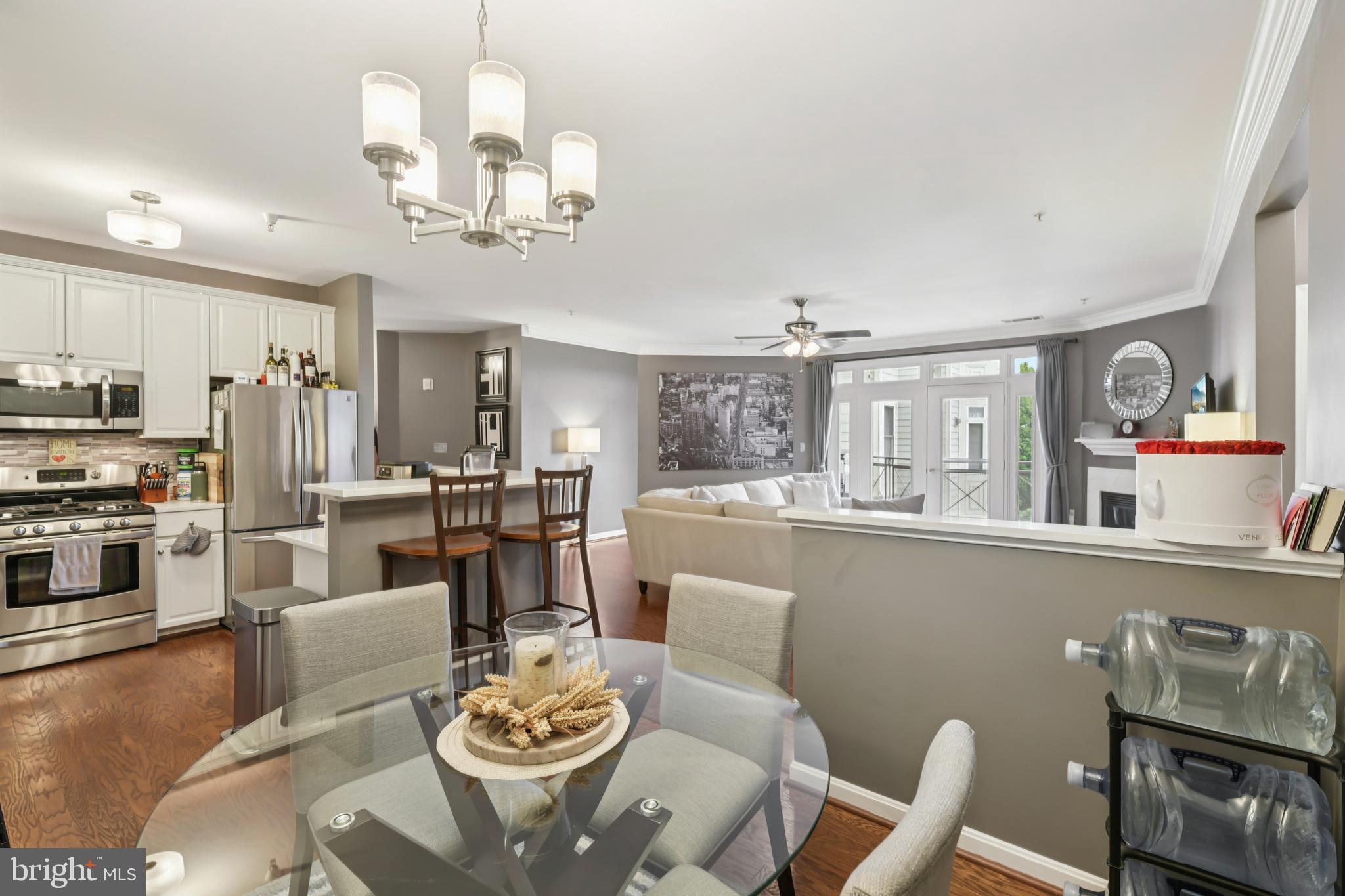 1621 Ladue Court, Unit 207 Woodbridge, VA 22191 - Photo 7 of 33 a dining room with furniture a kitchen view and wooden floor