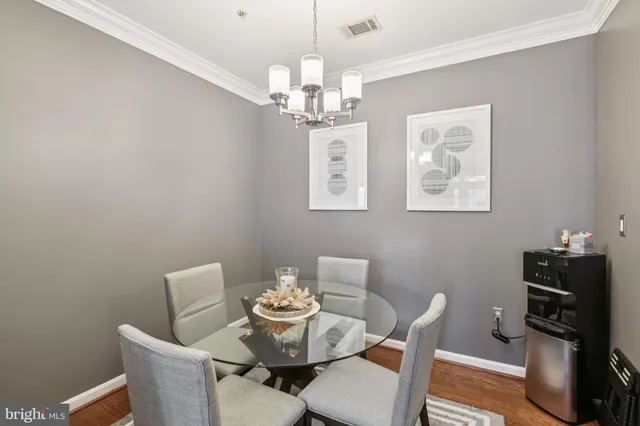 a dining room with furniture and chandelier