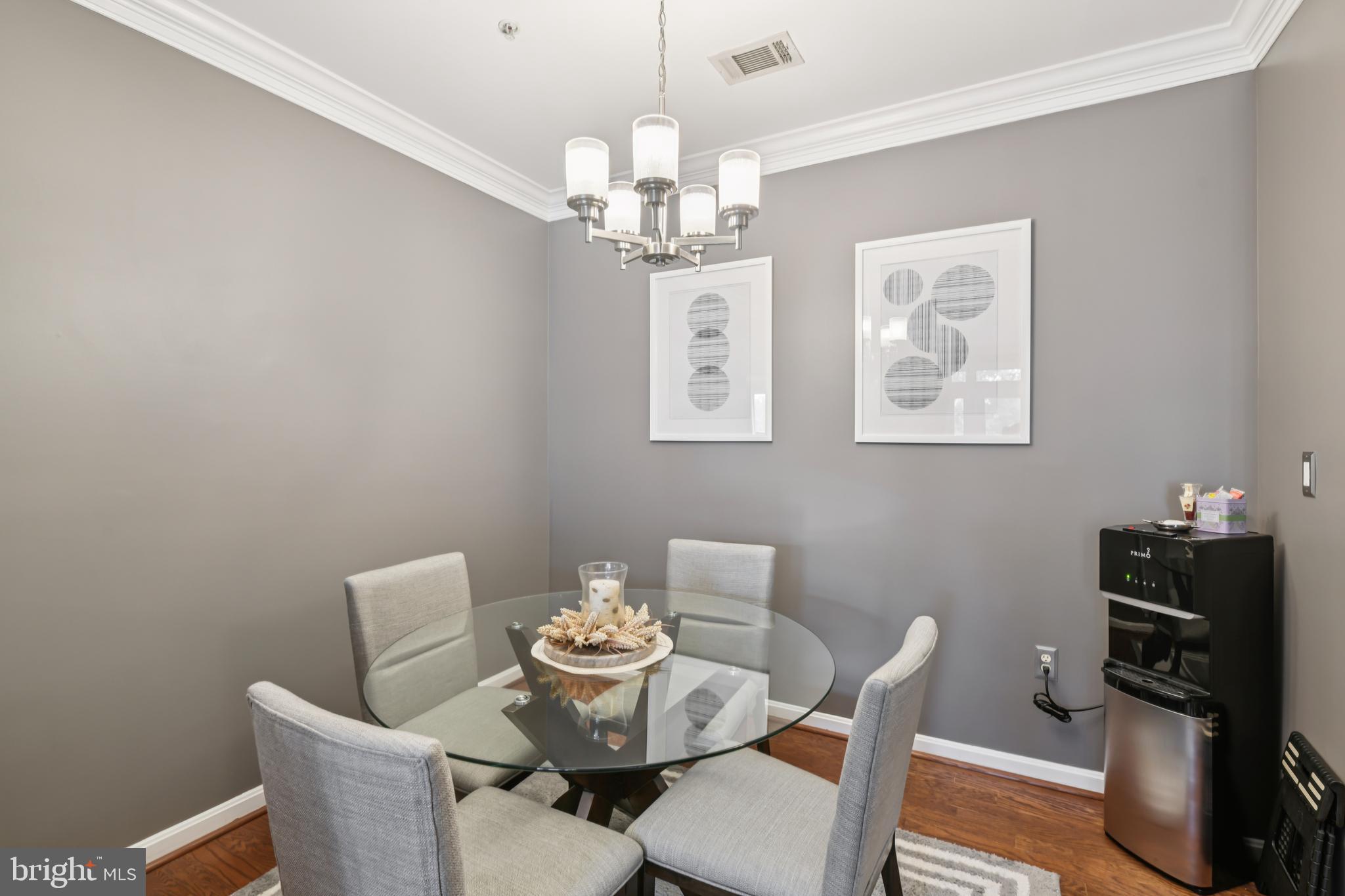 1621 Ladue Court, Unit 207 Woodbridge, VA 22191 - Photo 8 of 33 a dining room with furniture and chandelier