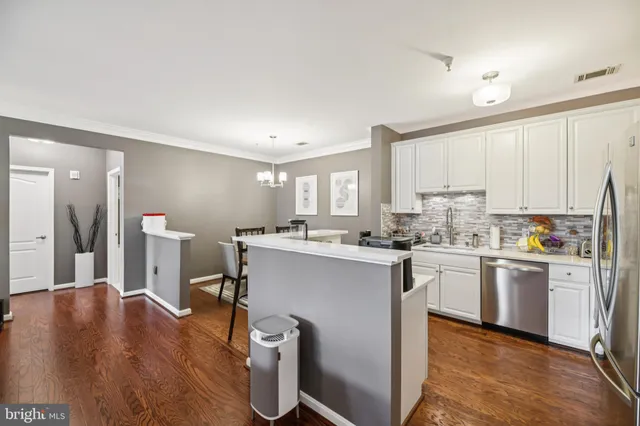 a kitchen with appliances a sink a counter top space and cabinets