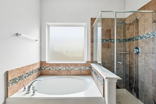 a bathroom with a bath tub and shower