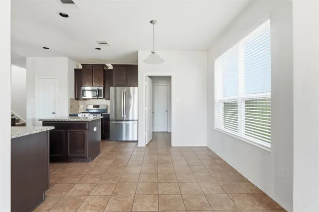 a large kitchen with cabinets and stainless steel appliances