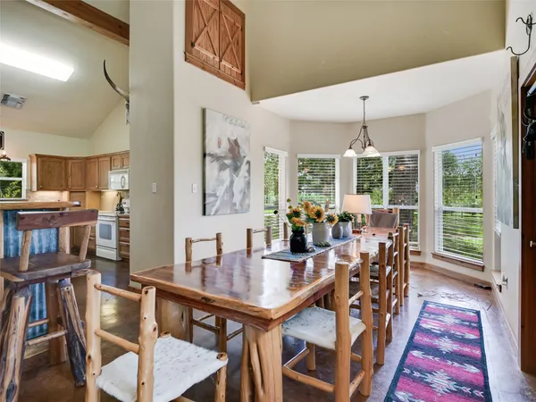 a view of a patio with table and chairs and wooden floor