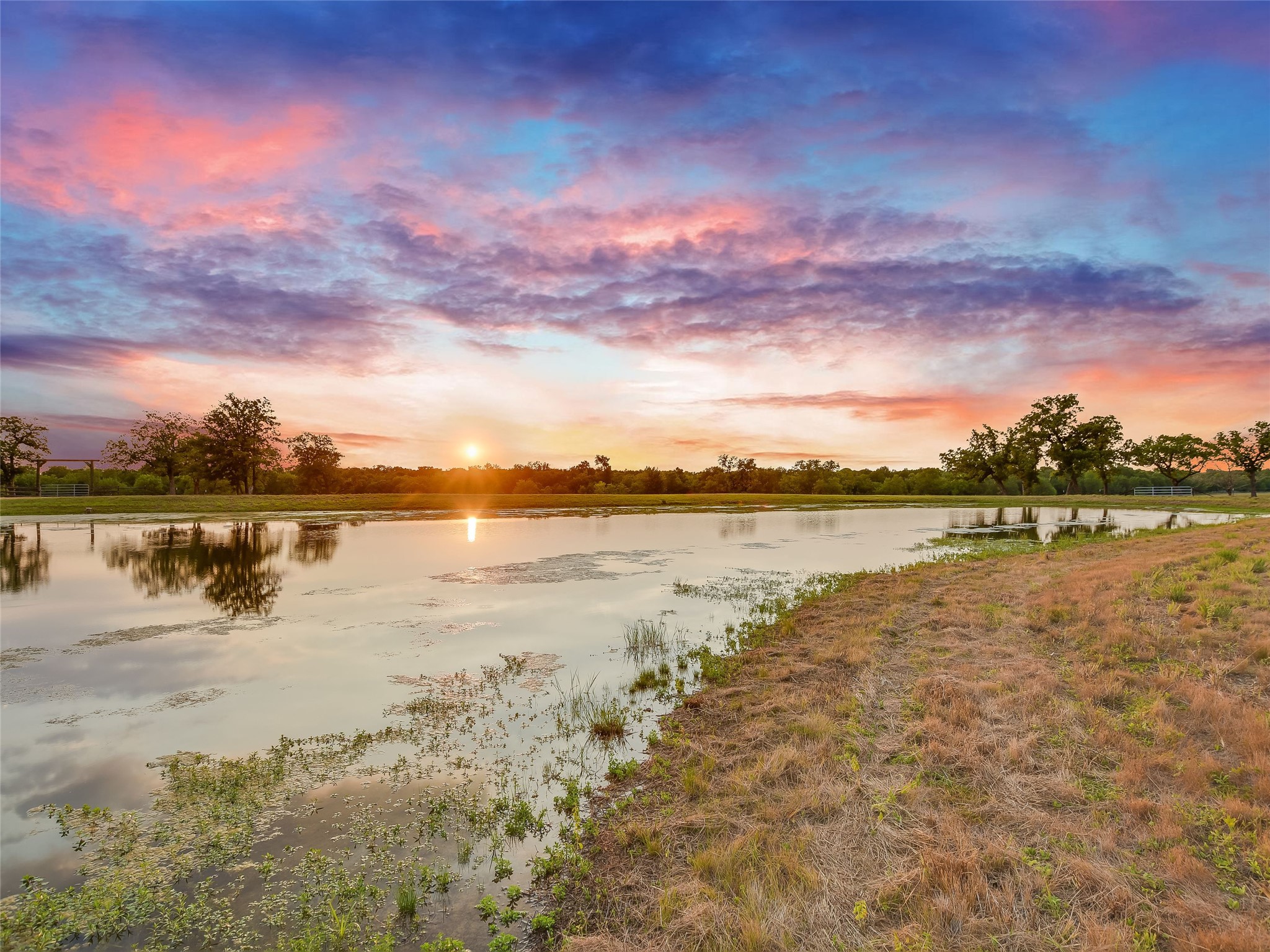 762 Karisch Road Smithville, TX 78957 - Photo 2 of 40 a view of a lake with a building in the background
