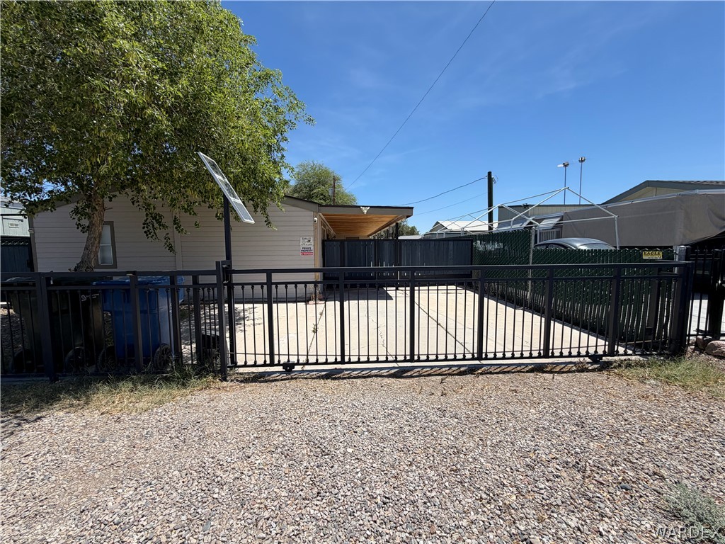 Gated concrete patio area with a sliding metal gate