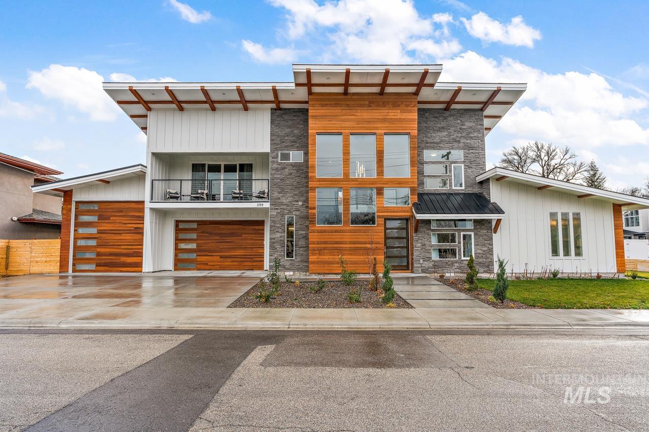 599 West Warren Street Boise, ID 83706 - Photo 3 of 41 Modern architectural exterior featuring wood-finish siding, stone accents, and white board-and-batten panels