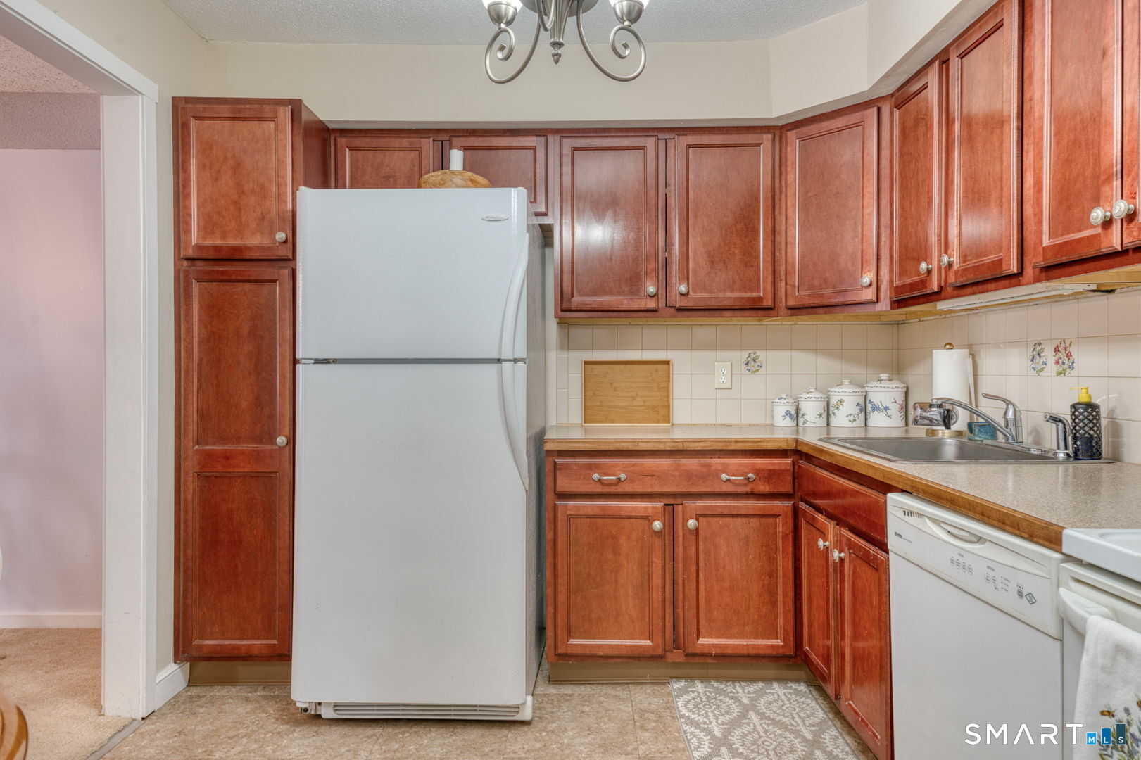 40 Hickory Hill Road, Unit 40 Southington, CT 06489 - Photo 10 of 35 a white refrigerator freezer sitting in a kitchen