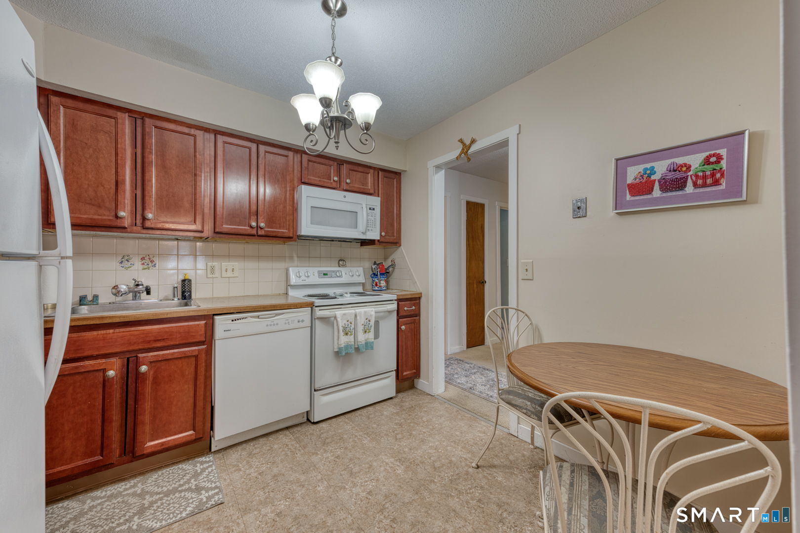 40 Hickory Hill Road, Unit 40 Southington, CT 06489 - Photo 12 of 35 a kitchen with stainless steel appliances granite countertop a sink stove and refrigerator
