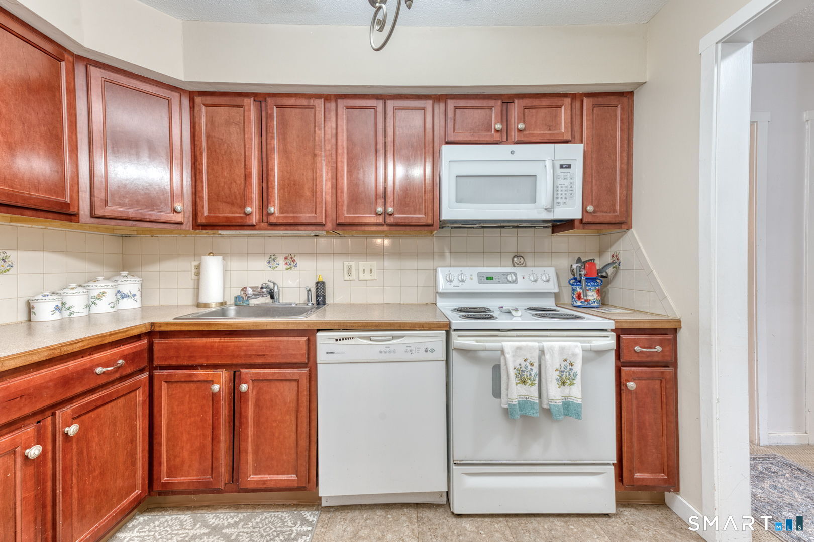40 Hickory Hill Road, Unit 40 Southington, CT 06489 - Photo 13 of 35 a kitchen with stainless steel appliances granite countertop a stove a sink and a microwave