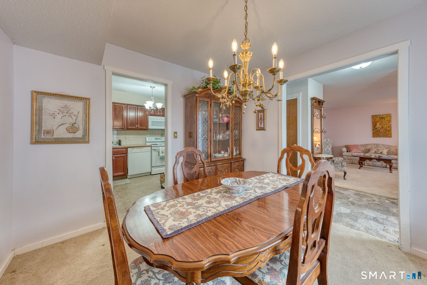 40 Hickory Hill Road, Unit 40 Southington, CT 06489 - Photo 16 of 35 a view of a dining room with furniture and a chandelier