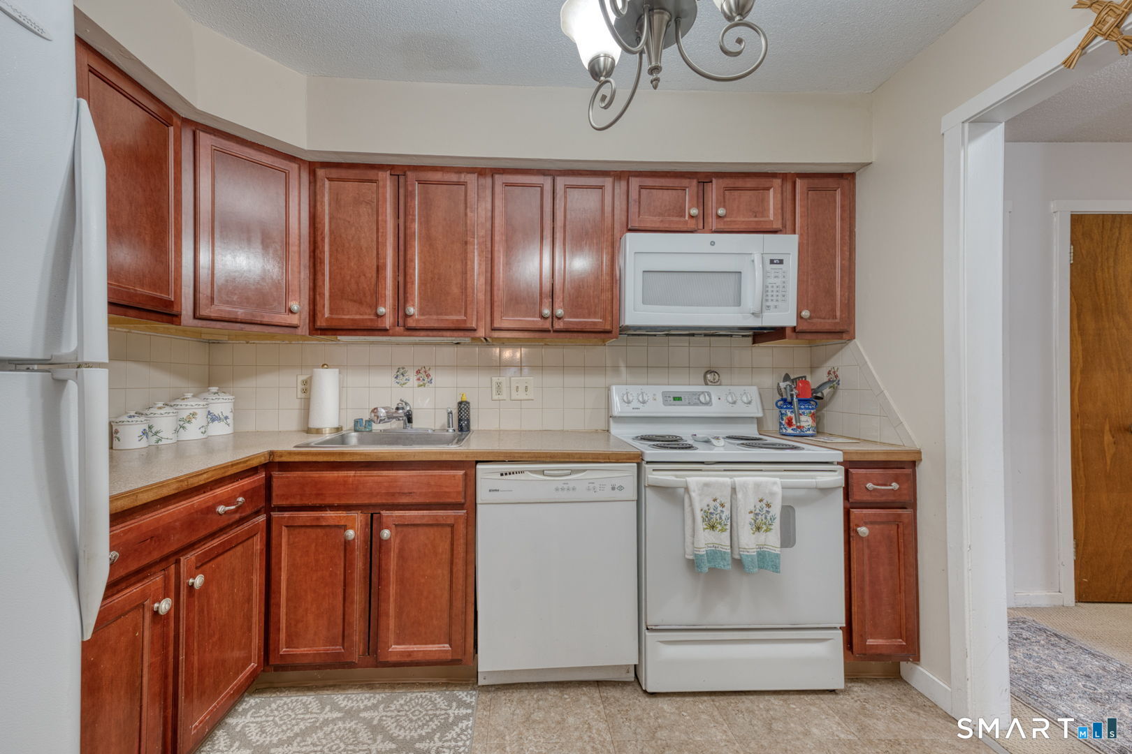 40 Hickory Hill Road, Unit 40 Southington, CT 06489 - Photo 9 of 35 a kitchen with stainless steel appliances granite countertop a sink stove and cabinets