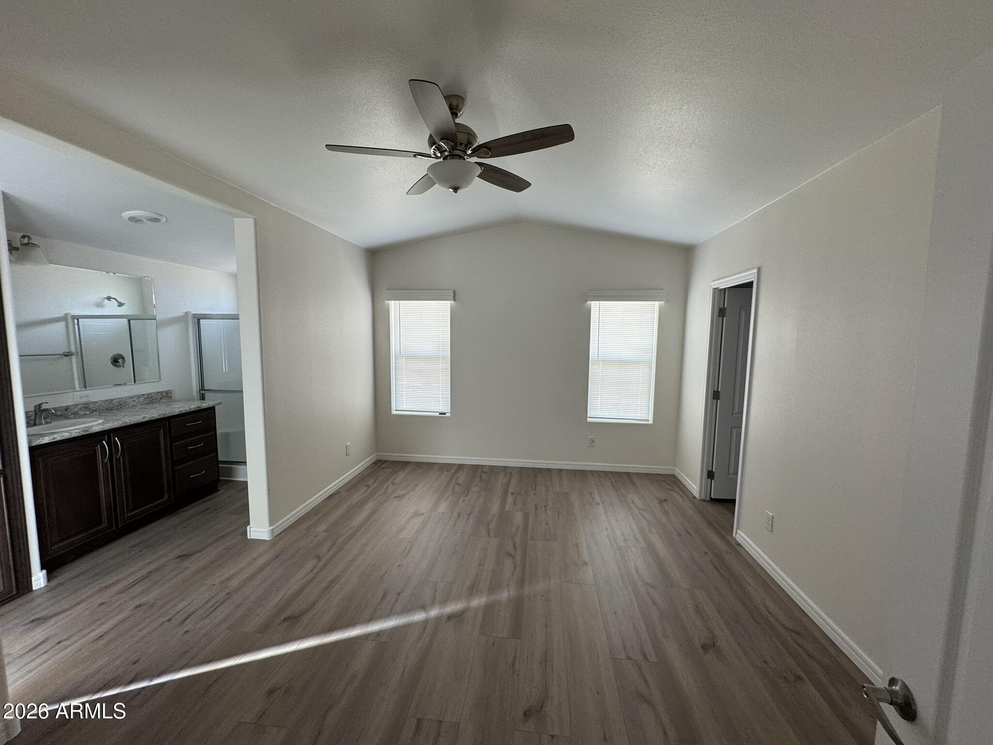 4123 Cowlic Road Golden Valley, AZ 86413 - Photo 12 of 15 a view of a livingroom with a ceiling fan and wooden floor