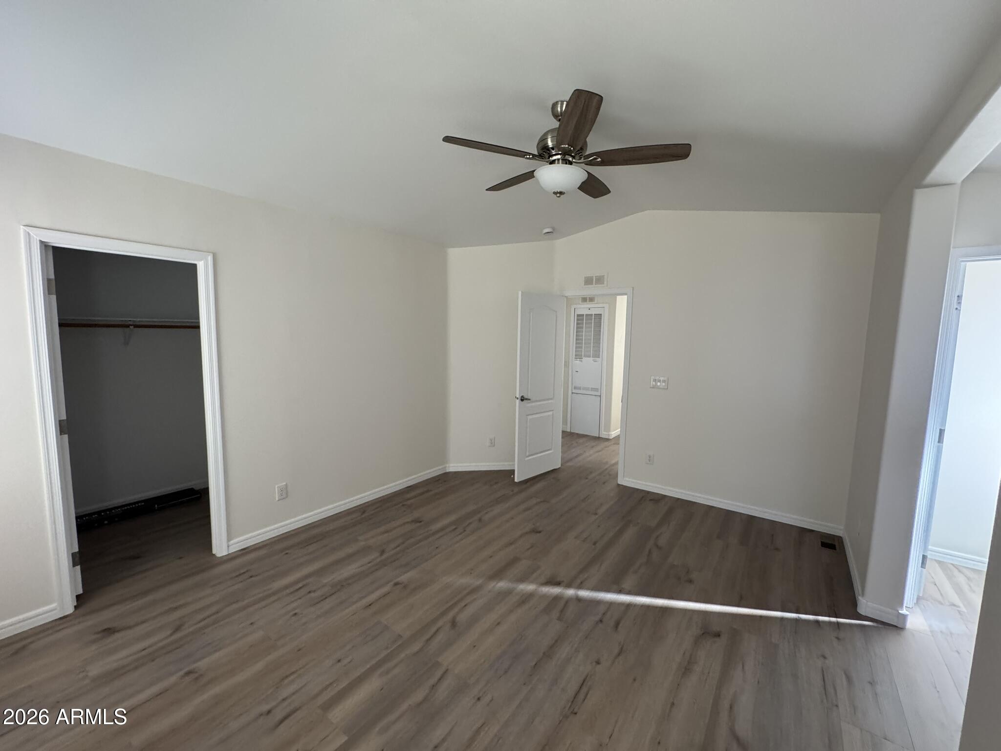 4123 Cowlic Road Golden Valley, AZ 86413 - Photo 14 of 15 an empty room with wooden floor closet and windows
