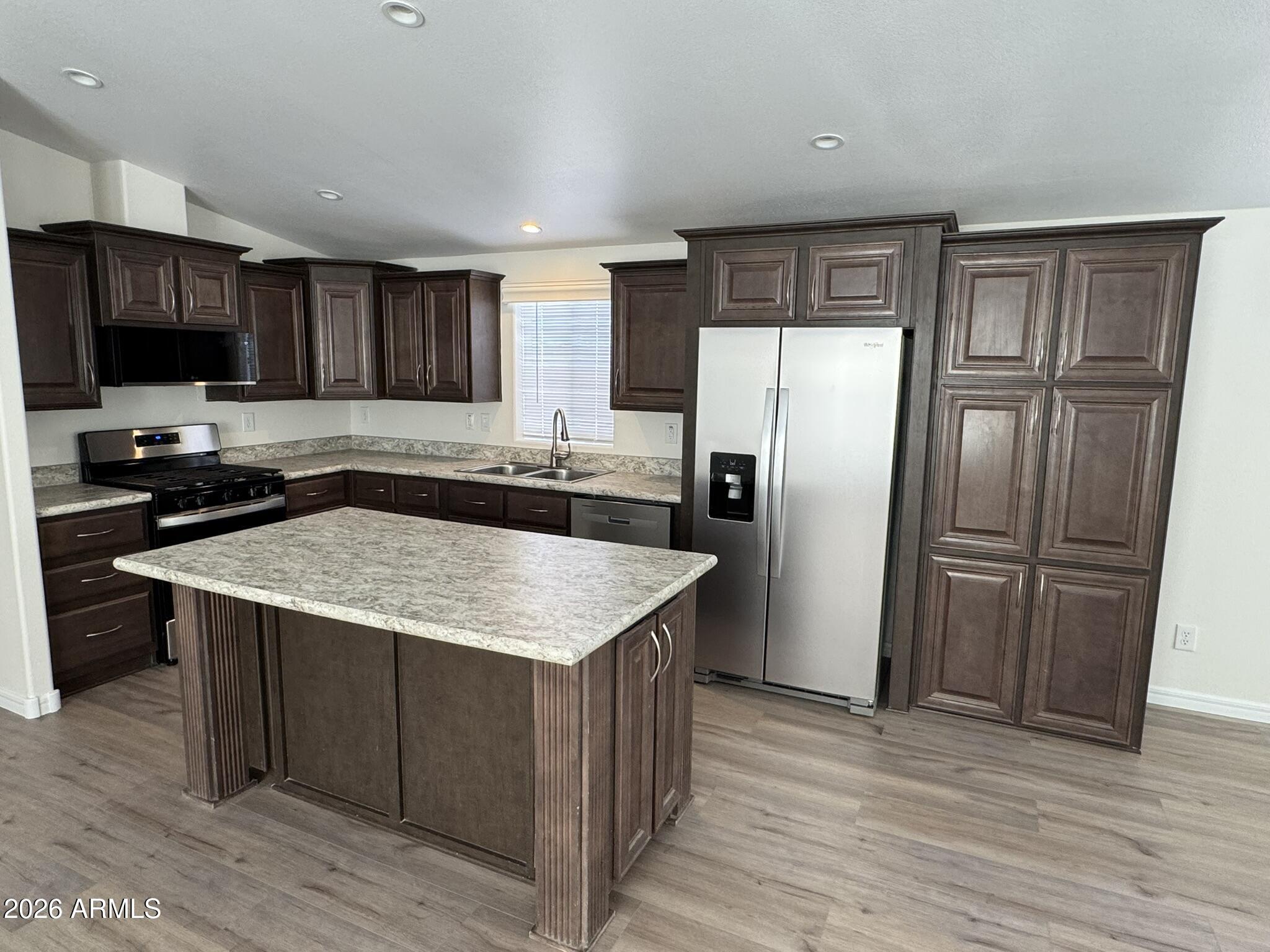 4123 Cowlic Road Golden Valley, AZ 86413 - Photo 7 of 15 a kitchen with a sink a refrigerator and a stove top oven