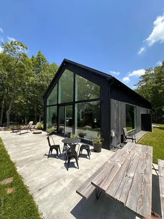 a view of backyard with swimming pool and furniture